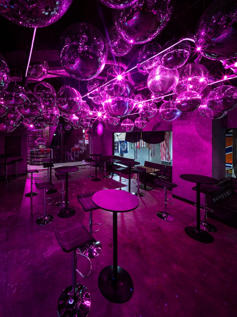 The mirror-ball ceiling and a high table in the foreground (portrait)