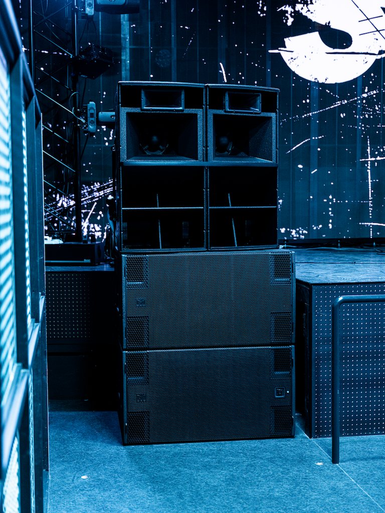 Speakers stacked beside the stage